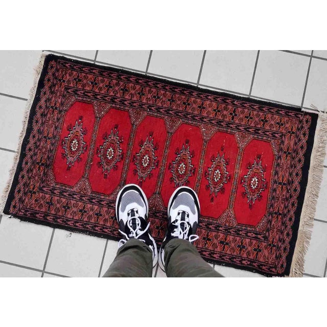 Handmade vintage Uzbek Bukhara rug in traditional design. The rug is from the end of 20th century made in wool....