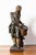 This 19th-century French sculpture features a young drummer, captured in a moment of intense focus and energy. Rendered in...
