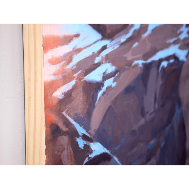 This oil on panel artwork captures a dramatic landscape of rugged boulders blanketed in snow, illuminated by the soft glow...
