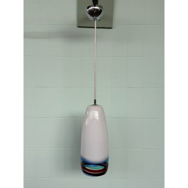 An elegant and refined Murano blown glass pendant lamp, handcrafted by Massimo Vignelli for the prestigious Venini...