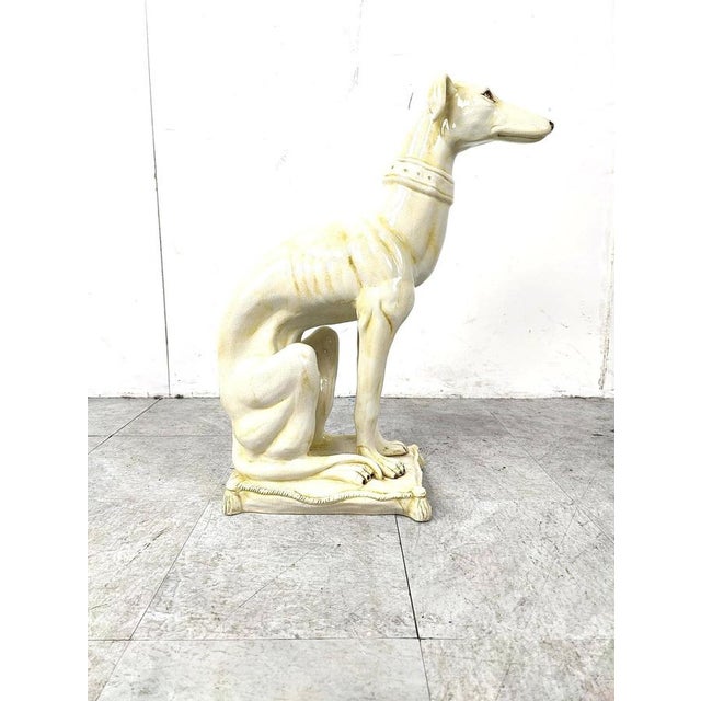 Gorgeous and naturally sculpted sculpture of a sitting greyhoudn made from cracklé ceramic and made in italy. Beautiful...