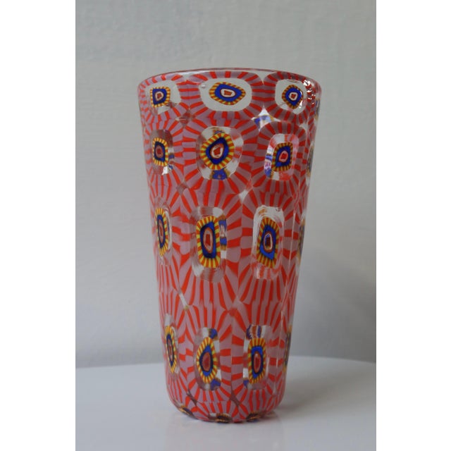 Hand-blown Murano glass vase featuring intricate murrine cane work in a vibrant palette of coral red, pale pink, cobalt...