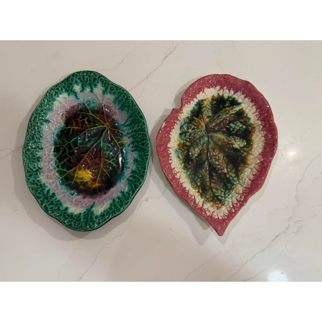 A stunning matched pair of antique majolica leaf-form dishes, featuring exceptional high-relief molding that captures the...