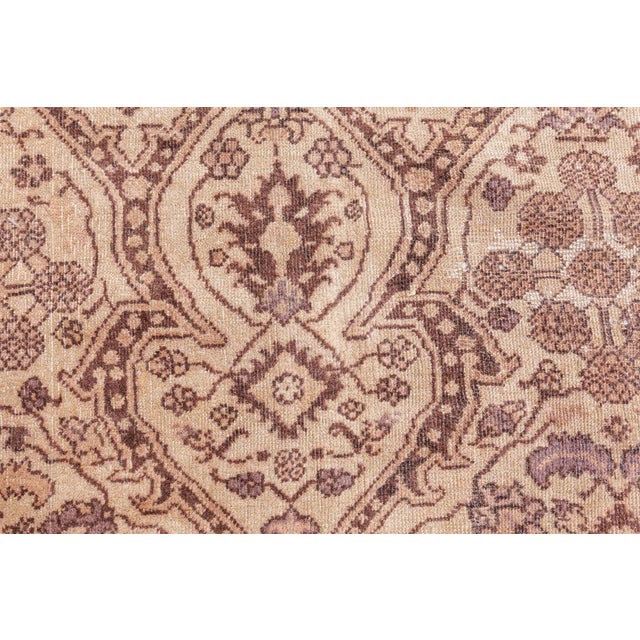 An early 20th century Indian Amritsar antique rug , the abrashed beige field with an allover lozenge lattice of cusped...