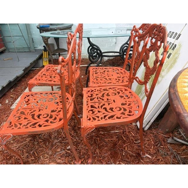 This set of 4 vintage orange iron garden patio chairs is a unique and stylish addition to any outdoor space. Made from...