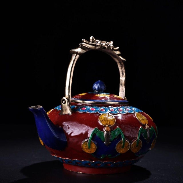 This striking vintage cloisonne enamel teapot is a beautiful example of traditional craftsmanship. The body is decorated...