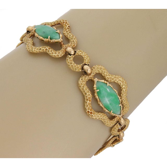 This is an estate bracelet, crafted from 18 yellow gold featuring 5 fancy open floral shape link with a textured finish,...