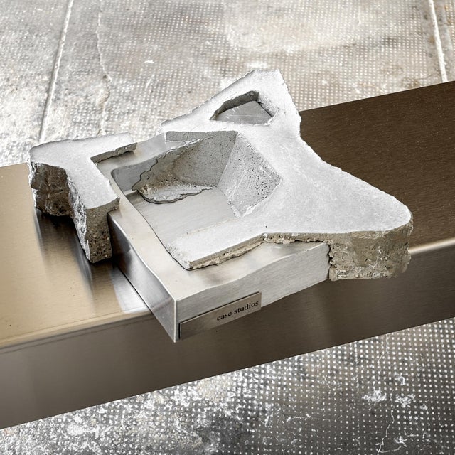 Massive Tray made from Wavy Stainless Steel, embedded in a Sculptural Concrete Shell. Each Object is individual in shape...