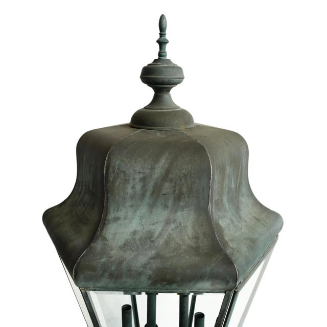 Vintage copper post lantern featuring a classic hexagonal form with beveled glass panels and a six-light candelabra...