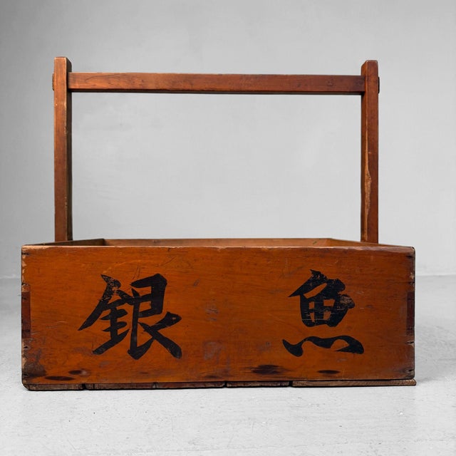 Characterful Japanese wooden carrying crate with an elegant high handle and black calligraphy on both sides. Originally...