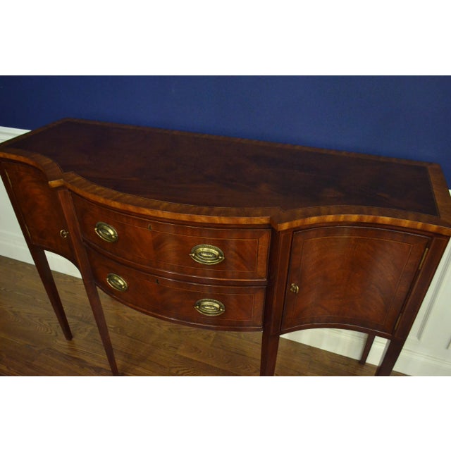 This is a new traditional mahogany sideboard. It’s design was inspired by the Hepplewhite sideboards from the Regency...