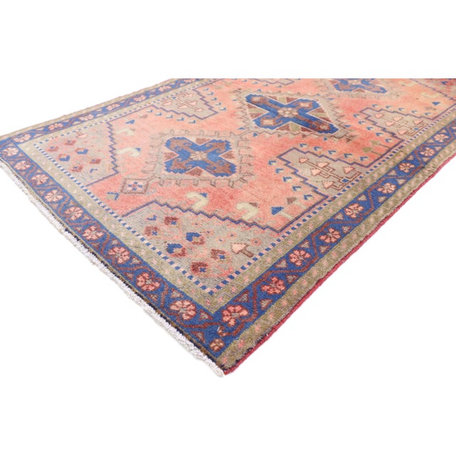 This hand knotted wool vintage Persian Viss accent rug features three latch-hook amulets each filled with a cruciform...