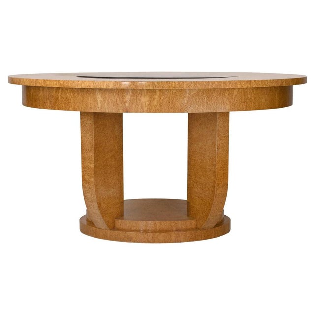 Vintage round dining table realized in Art Déco style by a french manufacturer in 1930s. Bird’s-eye maple veneer, ebonized...
