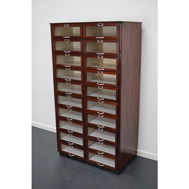 This haberdashery cabinet was produced during the 1930s in the Netherlands. This piece features 20 drawers in mahogany...