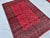 This hand-knotted Khal Mohammadi rug features two columns of small octagonal guls floating in an open crimson field,...