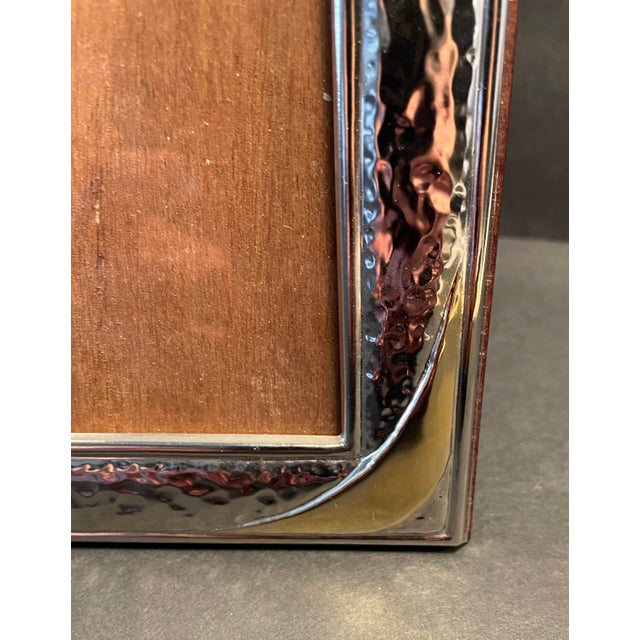 Hammered silverplate photograph frame with brass corner swags. Very nice wooden back and marked on silver with an "ARG...