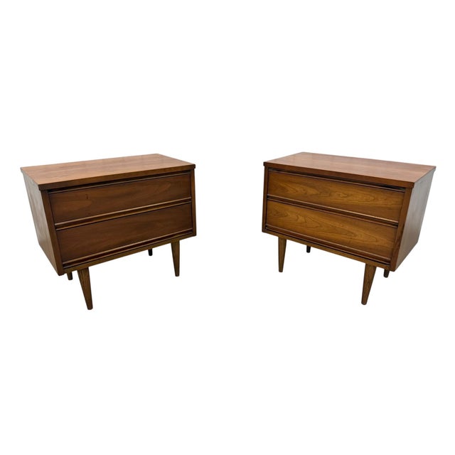 Elevate your bedroom with this exceptional pair of authentic mid-century modern walnut nightstands, crafted in the 1960s....