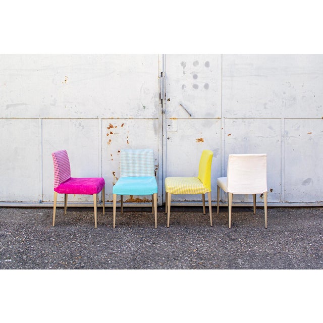 Chairs with padded seat and backrest upholstered in fabric and nickel-plated steel legs. Melandra model Designer Antonio...