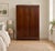 An antique Compactum wardrobe in dark oak, featuring decorative brass handles, carved cornice detailing and turned feet....