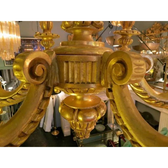 A six-arm elaborately carved and gold giltwood Rococo style chandelier. Rewired and in very good order, late 19th century...