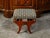 An Austrian Biedermeier period walnut stool from the 19th century, with upholstered seat and gilt rosettes. Created in...