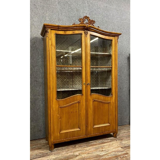 Louis XV Library in light wood around 1800 facade opening by paneed and glazed leaves discovering a pretty interior fully...