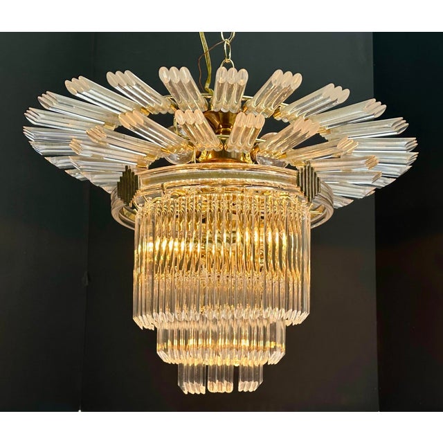Very unusual circa-1990s brass and Lucite Art Deco Revival chandelier crowned with a two-tiered starburst. Takes 7...