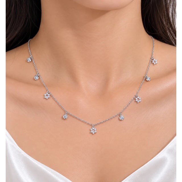 Elegant 14K white gold necklace featuring a Star of David design with 9 brilliant round diamonds totaling 0.6 carats....