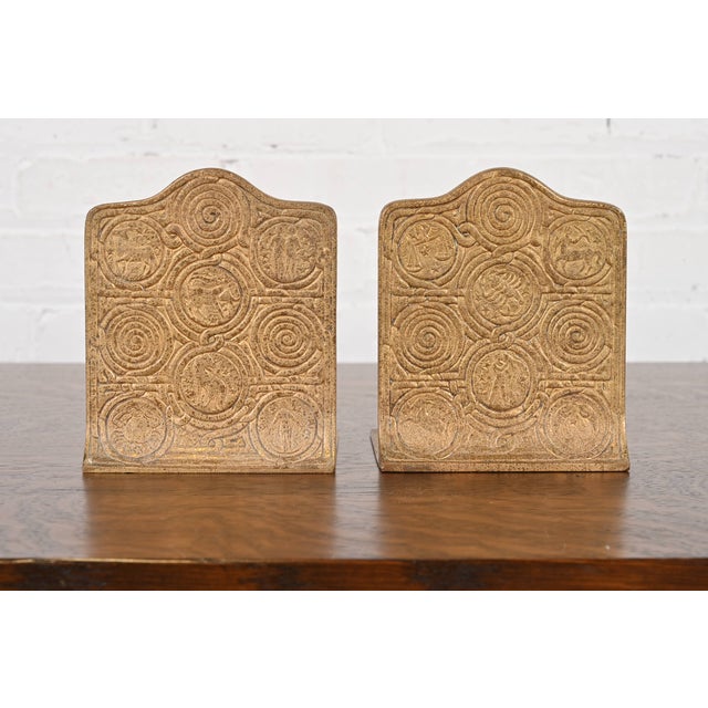 A gorgeous pair of Arts & Crafts or Art Deco period gilt bronze bookends featuring Zodiac designs By Tiffany Studios...