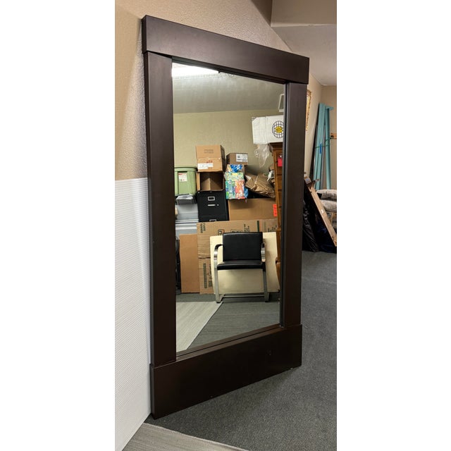 Design Plus Gallery presents a Burnished Metal Floor Mirror from Crate & Barrel. The mirror has a thick frame in a bronze...