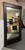 Design Plus Gallery presents a Burnished Metal Floor Mirror from Crate & Barrel. The mirror has a thick frame in a bronze...