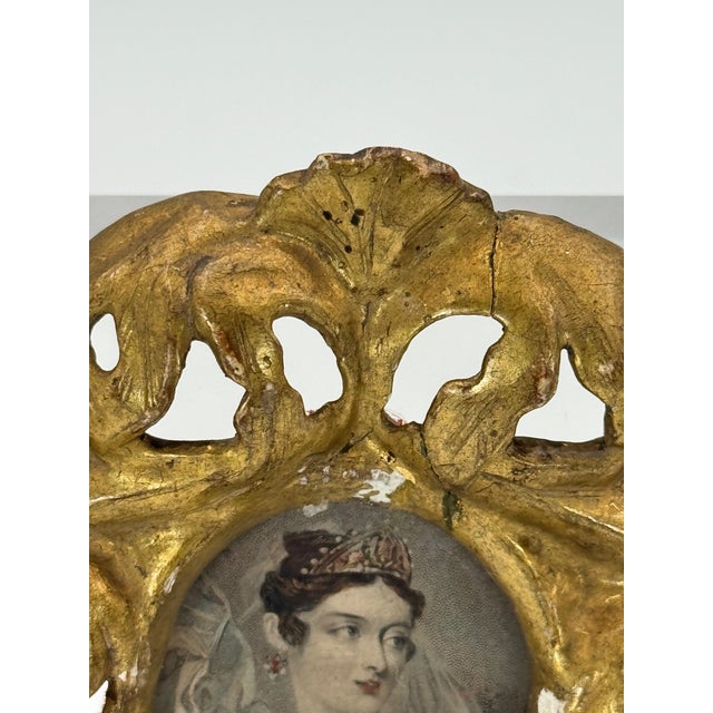 This charming small-scale decorative piece features an antique hand-carved wood frame, finished in aged gilt with...