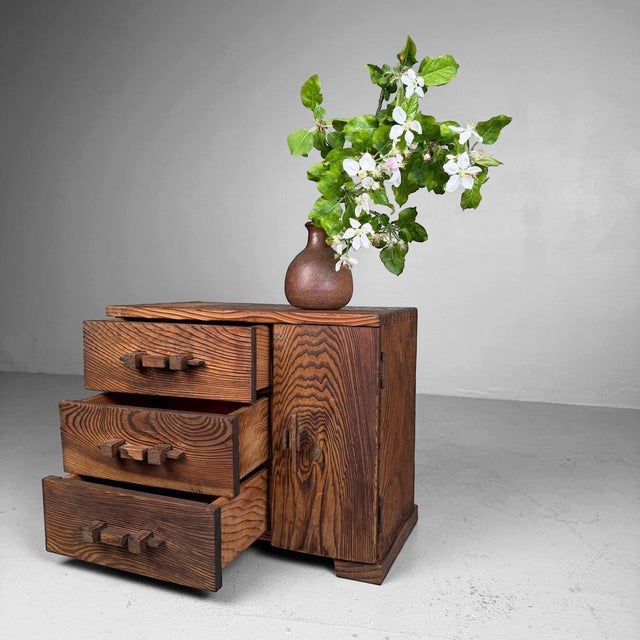 Small Japanese display cabinet from the 1950s–1960s, made of sugi, Japanese cedar. The piece has a compact form with one...