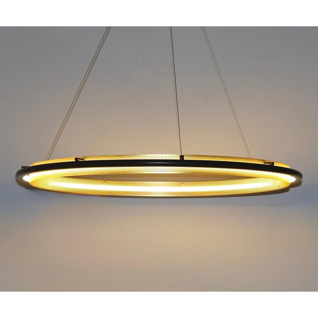 This single hoop pendant chandelier light has a brass metal perforated piece lit by a led light. Adjustable height....