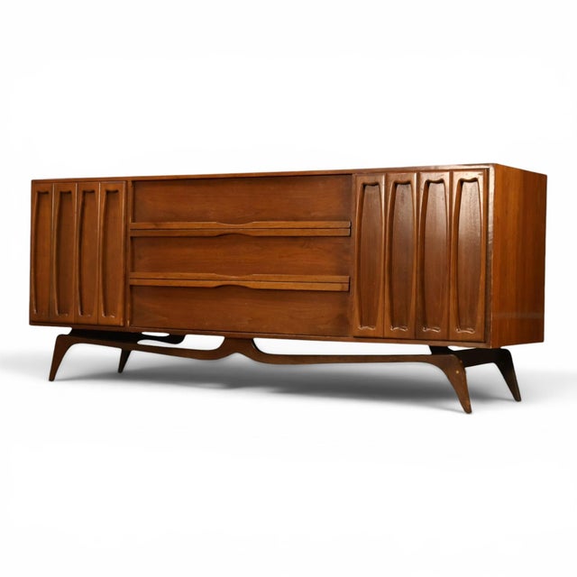This 1960s Tobago lowboy dresser is a sculptural piece of Canadian mid century modern design, built in walnut with a long,...