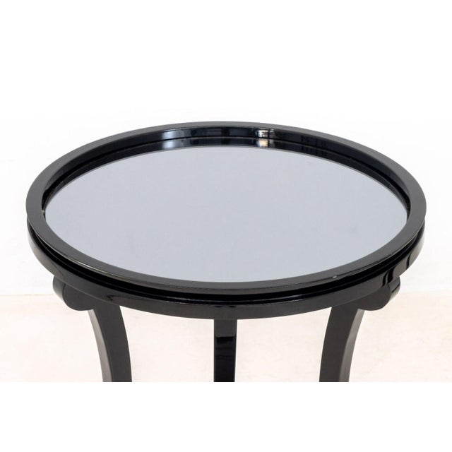Pair of Contemporary Mirrored Black Lacquered Side Tables, the circular top on three tapered legs. 23.75" H x 19.75"...