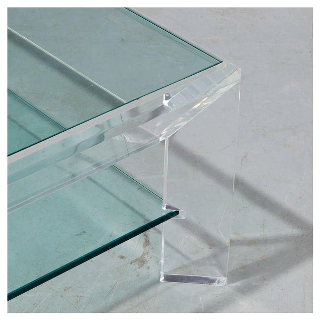 This vintage lucite and glass coffee table, designed in the style of Charles Hollis Jones, features a sleek and minimalist...