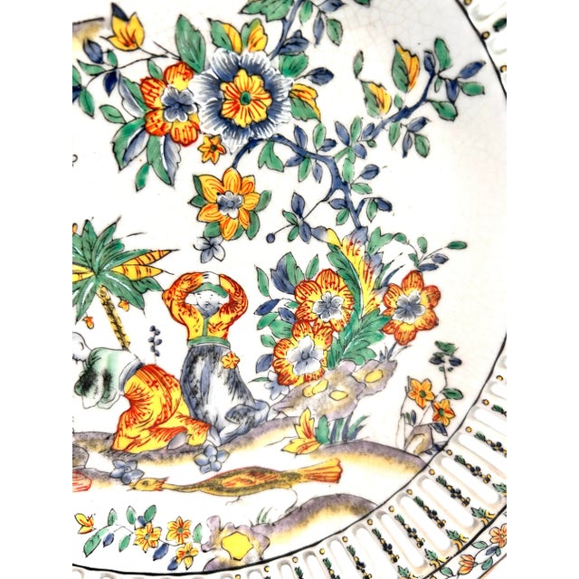 An elegant antique United Wilson porcelain plate dated 1897, featuring a delicate openwork rim and vibrant hand-decorated...
