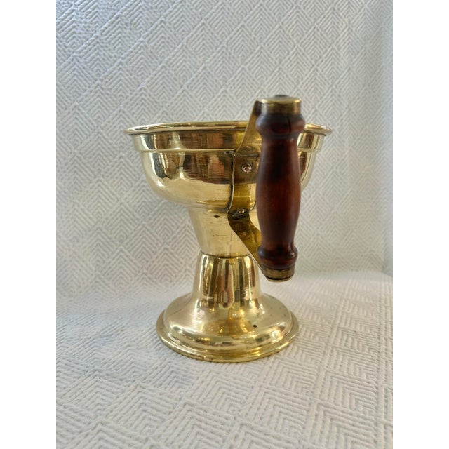 This is an antique brass coal hod or ember carrier featuring a pedestal form and hand-riveted construction. This hearth...