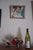 This oil on panel work depicts a cluttered table strewn with prescription bottles and medical paraphernalia, evoking a...