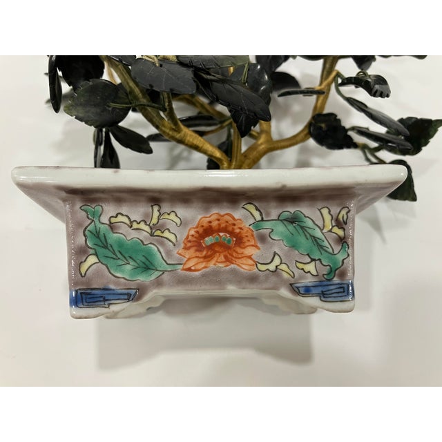 This floral display features the flowers made of stone and a hand painted container As an elegant accent it measures 7 H x...