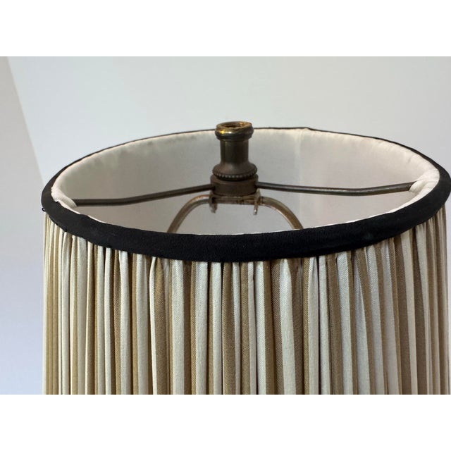 A unique mid-century painted wooden table lamp with accompanying custom shade. The lamp is hand painted in a deep shade of...
