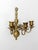 Vintage 1960s brass wall candle sconce featuring a three-arm candelabra design with ornate scrollwork, curled arms, and a...