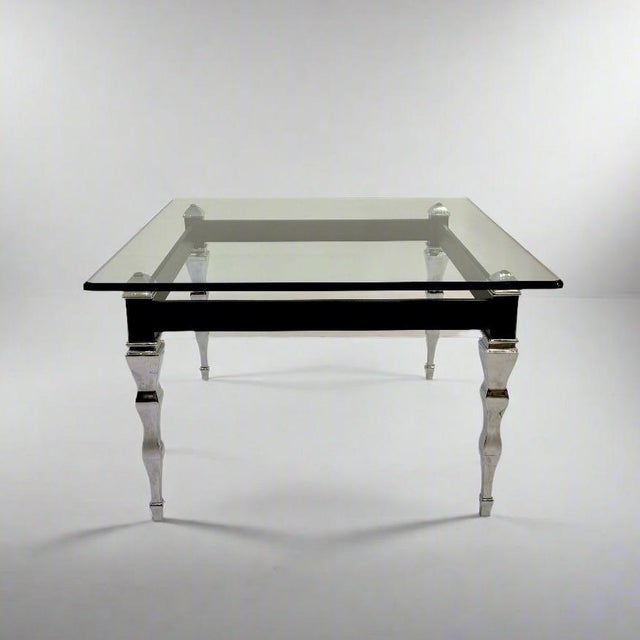 A Modernist square cocktail table with curiously shaped legs from Italy circa 1960.