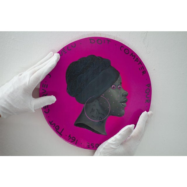 This contemporary artwork features a profile of a Black woman on a vibrant pink background, blending elements of pop art,...