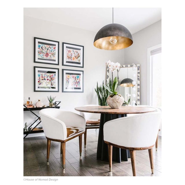 A simple dome shade brings sleek minimalism to the mix. Featuring a gold-leafed finish on the shade’s interior, this gives...