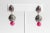 A pair of pave`-set, round-cut diamonds set in sterling silver with a faceted, pear-shaped ruby on the post also...