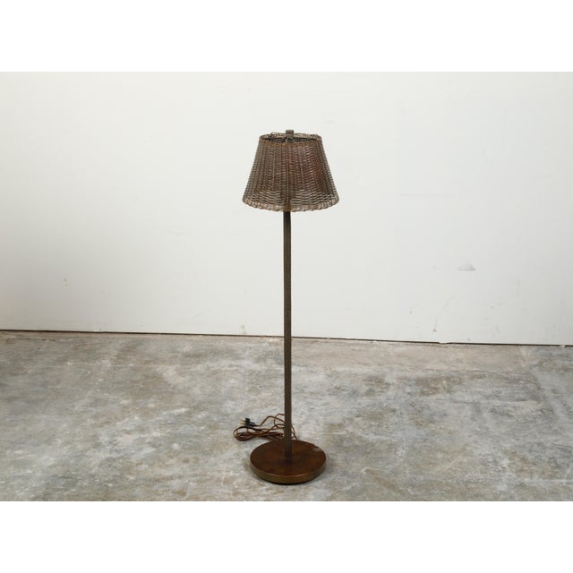An English vintage woven basket adjustable floor lamp from the mid 20th century with single light, wired for the US....