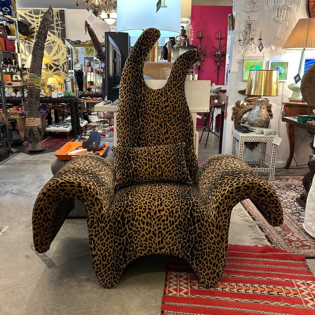 Exquisite Post Modern very fun and elaborate arm chair. Upholstered in a soft leopard print fabric with flowing arms and a...