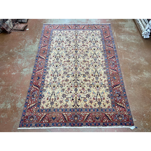 Vintage Persian Tabriz rug, hand knotted in Iran from 100% wool. Measuring 7’7” x 10’11”, the rug features an intricate...